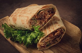 Cut shawarma, 2 pieces, on a cutting board, close-up