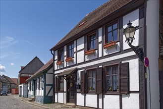 Half-timbered houses in the Lange Fischerstraße, covered with cobblestones, in the old town of