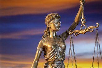 Close-up of a Justitia in front of a beautiful evening sky