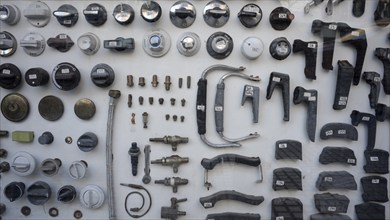 View into the shop window of an antiquarian plumbing shop with numbered spare parts of all kinds,