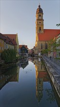 The setting sun bathes everything in warm light and reflects the Basilica of St Martin in the River