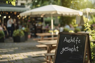 Chalkboard with German text 'Aushilfe gesucht' (hiring staff) at restaurant. Generative AI, AI