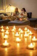 Symbolic image energy saving, cold winter, energy crisis, cold flat, mother and daughter lying on