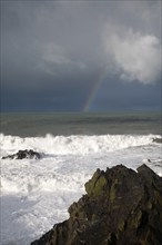 Large Atlantic storm waves crashing onto jagged rocky coast at Hartland Quay, north Devon, England,