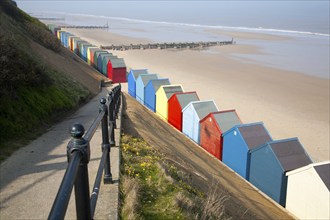 Colourful beach huts, wide sandy beach and sea, Mundesley, Norfolk, England, United Kingdom, Europe