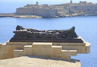 Recumbent figure sculpture by Michael Sandle memorial for 1940-1943 siege, Grand Harbour, Valletta,