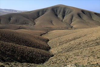 Bare moon-like arid landscape in mountains between Pajara and La Pared, Fuerteventura, Canary