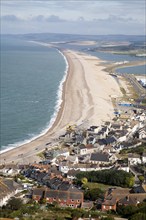 Chesil beach tombolo with housing in Chiswell in the foreground, Isle of Portland, Dorset, England,