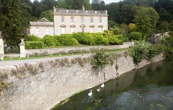 River Frome and the classical Georgian facade of Iford Manor, near Freshford, Wiltshire, England,