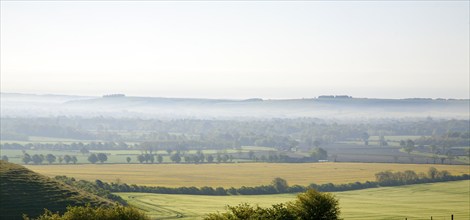 Early morning ground fog lying over fields in the Vale of Pewsey, near Alton Barnes, Wiltshire,