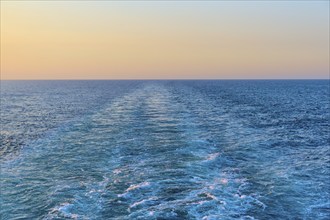 View from the cruise ship at sunset at the stern of the ship onto the stern waves, North Sea,
