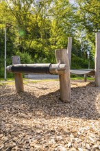 Close-up of a wooden bridge on a playground with wood chips as flooring, Nagold, Black Forest,