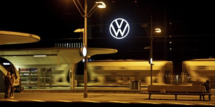 Wolfsburg main station at night with illuminated VW logo at the Volkswagen AG main plant, Lower