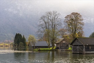 Lake Hallstatt near Steeg. Some boathouses. Autumn, backlight. Lake Hallstatt, Salzkammergut, Upper