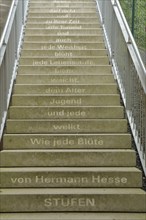 Staircase with poem Steps by Hermann Hesse, staircase with inscription, 'As every flower withers