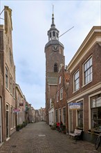 Alley with traditional houses and church in the town of Blokzijl, province of Overijssel,