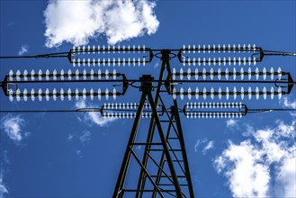 Insulators made of glass on a high-voltage line, they hang on the pylons as a suspension device