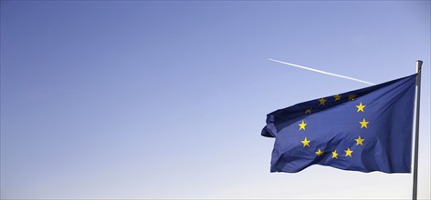 Flag of the European Union in front of a blue sky (Flag of the European Union in front of a blue