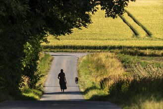 Woman walking her dog, going for a walk