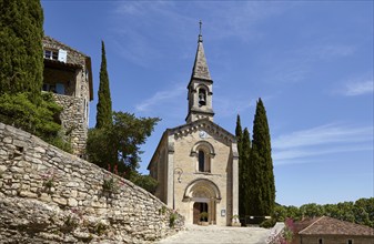 La Chapelle l'Eglise with mediterranean cypresses (Cupressus sempervirens) in La Roque-sur-Cèze,