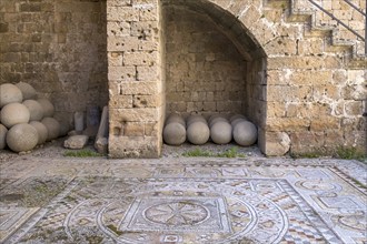 Floor mosaic and historical cannonballs, Archaeological Museum, former hospital of the Order of St