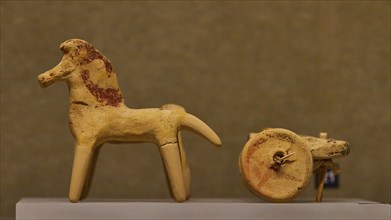 Ancient children's toy, Two simple clay figurines depicting a horse and parts of a cart,