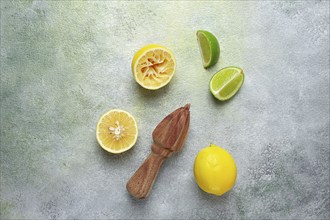 Wooden citrus reamer, manual lemon juicer, made of acacia wood, with citrus fruits on the table,