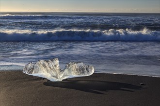 Ice floe on the beach, waves, sunny, morning mood, winter, Diamond Beach, Breidamerkursandur,