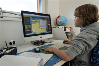 Young, primary school pupils, home learning, doing schoolwork, distance learning, virtual