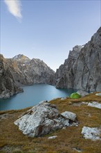 Wild camping, camping in the wilderness with a tent in front of mountain lake Kol Suu, Sary Beles