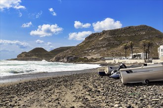 Fishing boats on a pebble beach, rocky coast, Cabo de Gata Natural Park, Las Negras, Almeria,