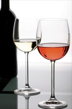 Two wine glasses filled with red wine and white wine, still life, studio