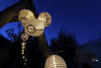 Lanterns, paper lanterns, fairy lights in a garden, blue hour, Germany, Europe