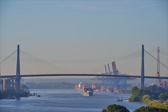 Köhlbrand Bridge over the Elbe, with passing ships and harbour cranes in the background, Hamburg,