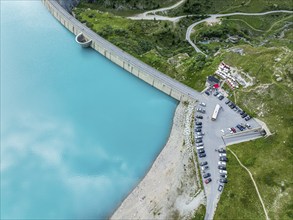 Dam of the Moiry lake, Lac de Moiry, turquoise glacial water, parking lot and restaurant at the