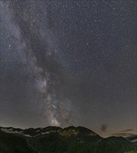 Nocturnal starry sky over the Furka Pass in the Swiss Alps. The night photograph shows the stars of