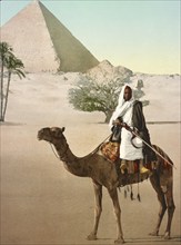 Cairo, Bedouin riding camel in front of pyramid, Egypt, digitally restored reproduction from a 19th