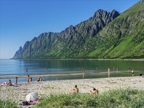 Beach Ersfjordstranden, fjord Ersfjord, public recreation area, summer, people go swimming, view to