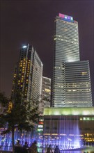 Modern buildings and fountains at night in a city park in Kuala Lumpur, Malaysia, Asia