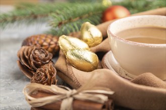 Christmas or New Year composition. Decorations, cones, cinnamon, fir and spruce branches, cup of