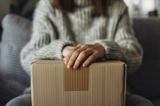 Woman's hands with closed cardboard box. Concept for shipping goods or moving house. KI generiert,