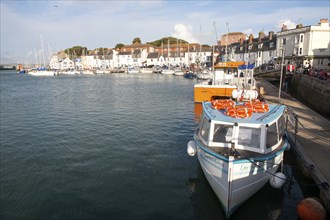 Colourful fishing boats in the harbour at Weymouth, Dorset, England, UK