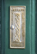 Historic brass letter box on door, Devizes, Wiltshire, England, UK