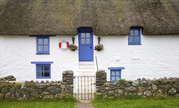 Traditional thatched whitewashed cottage in Porthallow village, Cornwall, England, United Kingdom,