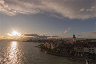 Cityscape, waterfront promenade, church tower, evening light, water reflection, Friedrichshafen on