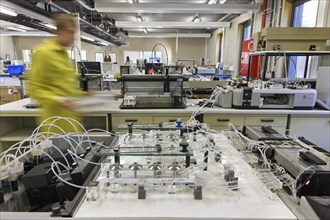 Analyst working on soil samples in agricultural analytical services laboratory