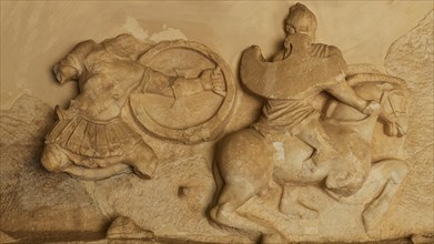 Stone relief of a horseman in battle, battle of the Greeks against the Amazons, richly detailed