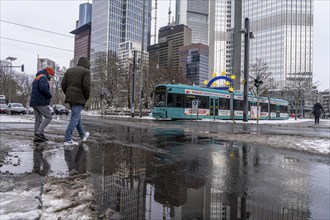 Winter in the city, Gallusanlage street, puddles, pools of water, melt water, pedestrians,