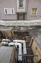 Construction site of a district heating house connection, pipes, insulated, are laid from a central