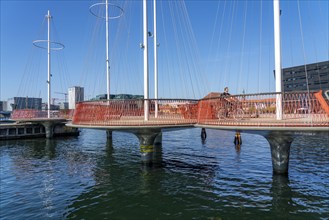 Cyclists on the Cirkelbroen cycle and pedestrian bridge, over the harbour, in the Christianshavens